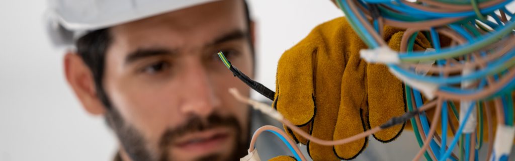 Electrician rewiring an old home's electrical system.