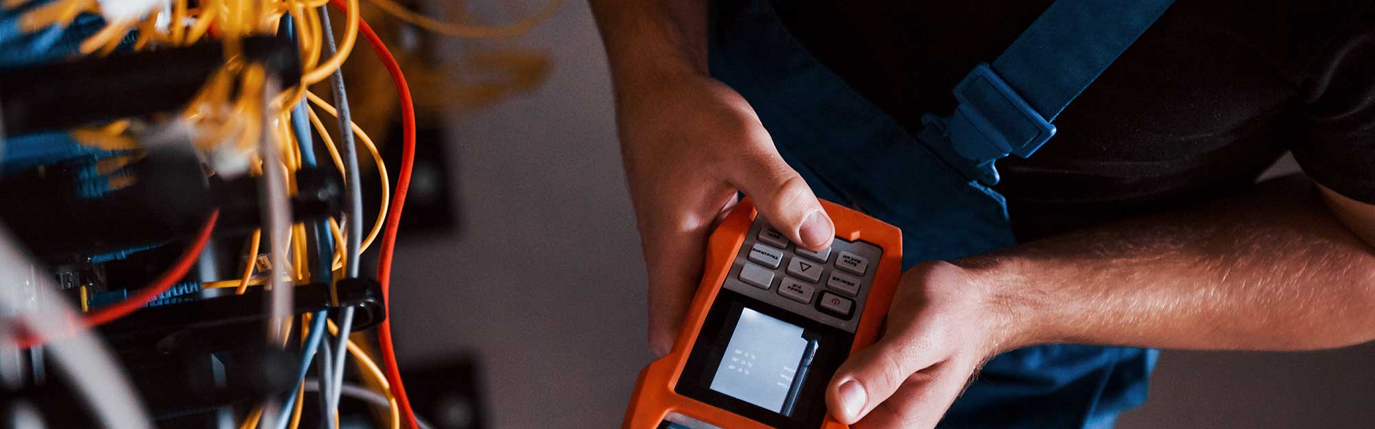 Electrician using diagnostic tools on the commercial electrical system