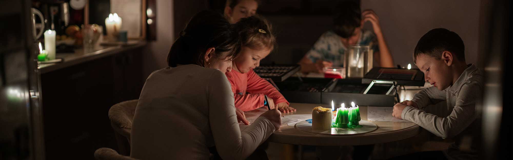 Family using candles for lighting during a power outage